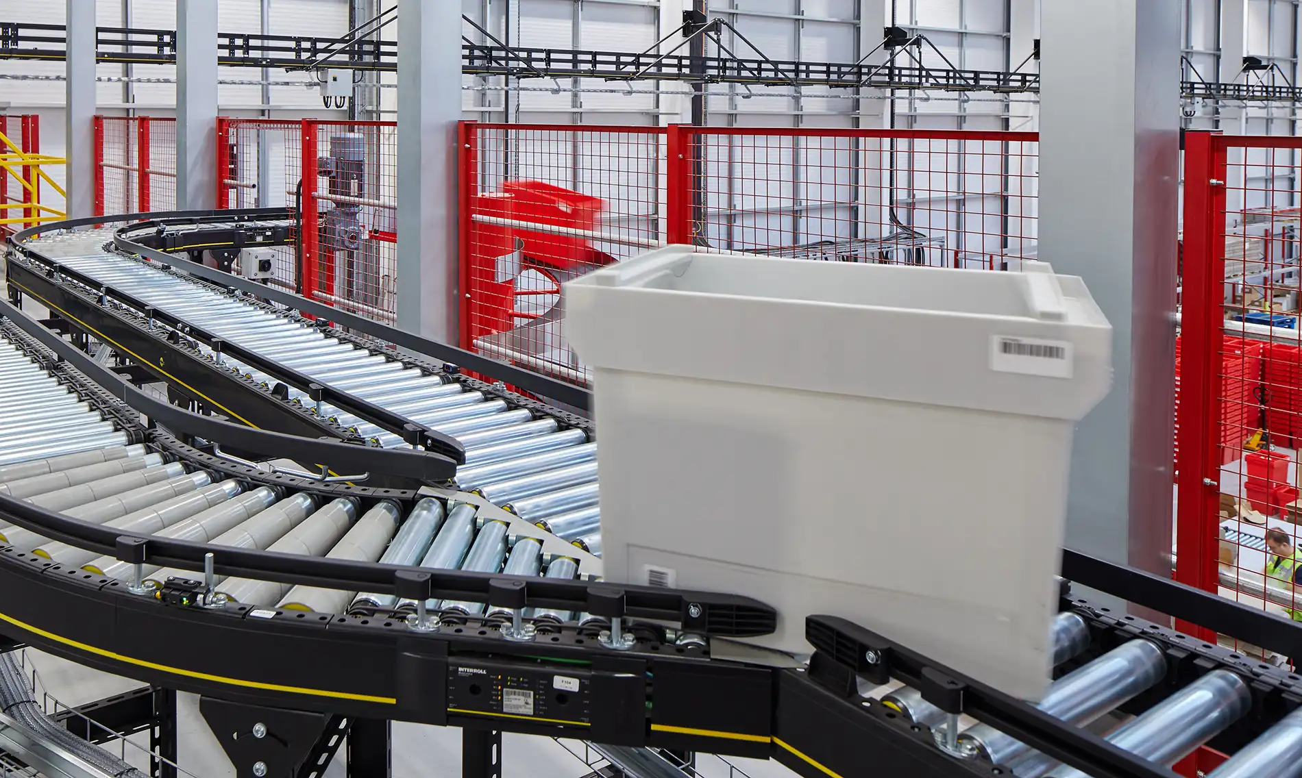 Interroll Roller Conveyor with CSL Logo. Logopak Label Printer Above.