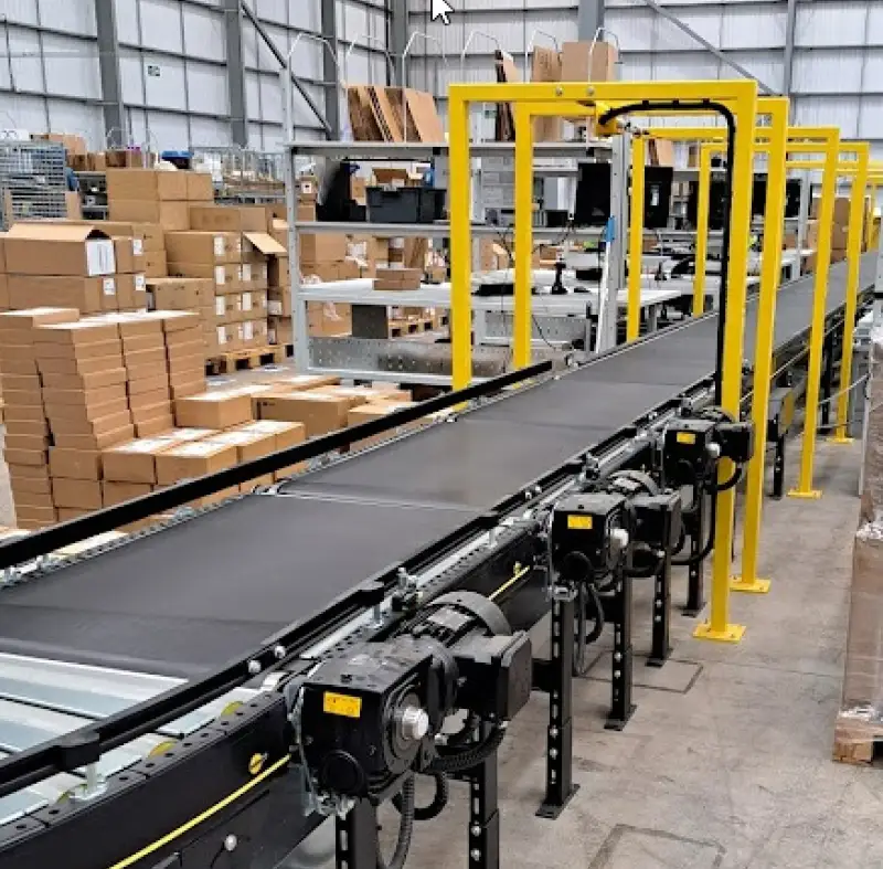 3PL packing belt section with overhead e-stop pull cord in warehouse