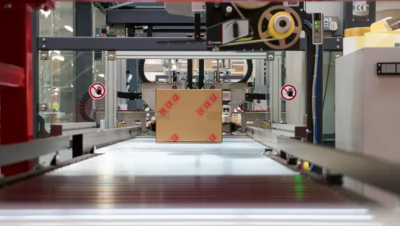 A package going through a Sparck automated packing machine