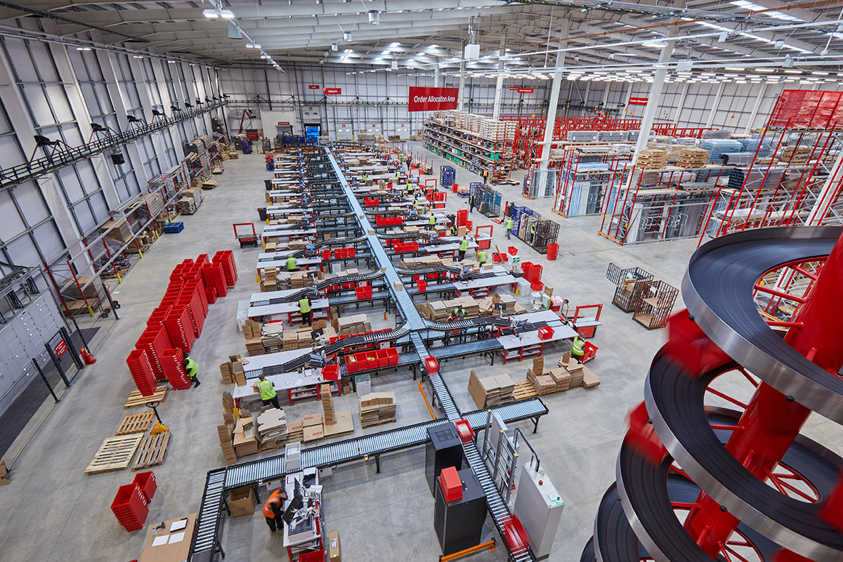 Interroll roller conveyor in packing area in automation warehouse for electrical wholesaler